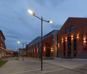 Extensive office complex exterior in loft style. Red brick buildings of former factory, gasholders....