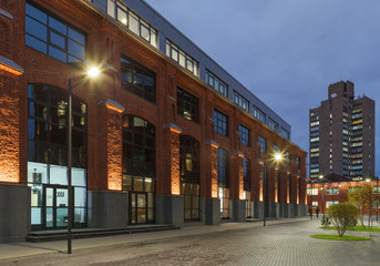 Extensive office complex exterior in loft style. Red brick buildings of former factory, gasholders....