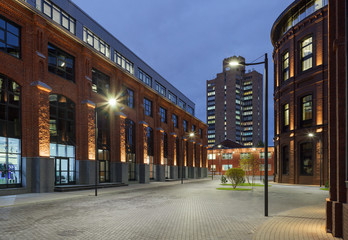 Extensive office complex exterior in loft style. Red brick buildings of former factory, gasholders....