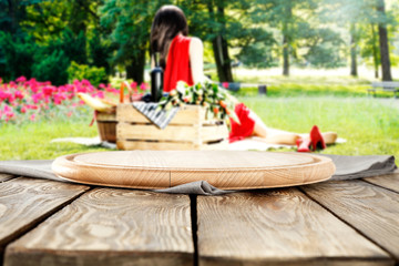 Obraz na płótnie Canvas wooden table and woman on grass 