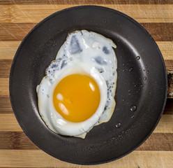 Breakfast with fried eggs  on wooden background