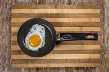 Breakfast with fried eggs  on wooden background