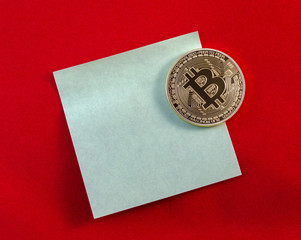 Golden Bitcoins (digital virtual money) on sticker and red backg