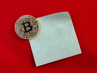 Golden Bitcoins (digital virtual money) on sticker and red backg