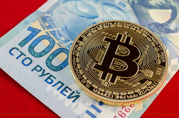 Golden Bitcoins (digital virtual money) and one hundred rubles