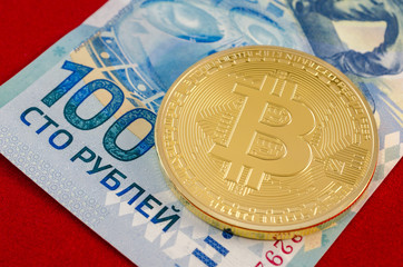 Golden Bitcoins (digital virtual money) and one hundred rubles