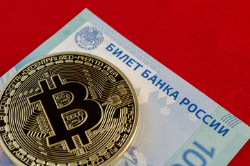 Golden Bitcoins (digital virtual money) and one hundred rubles