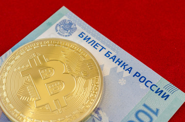 Golden Bitcoins (digital virtual money) and one hundred rubles