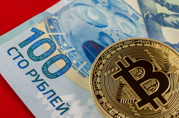 Golden Bitcoins (digital virtual money) and one hundred rubles