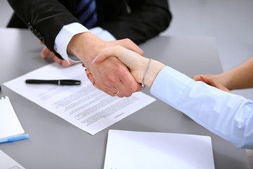 Business people shaking hands , finishing up a meeting to sign a new contract