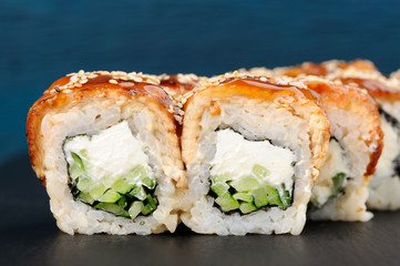 Yummy square sushi rolls with cream cheese and cucumber covered