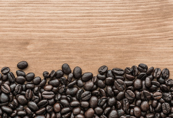 background of brown coffee beans on wood board