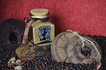 custom painted glass can with traditional aztec pictures coffee bean background with handmade round chocolate 