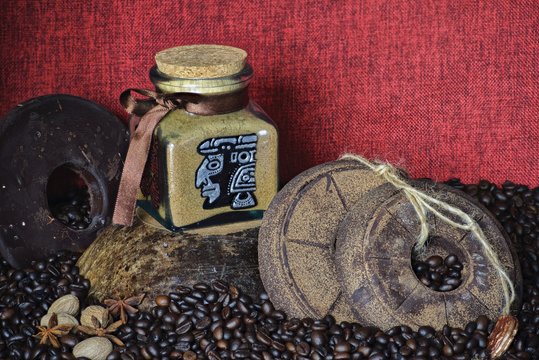 custom painted glass can with traditional aztec pictures coffee bean background with handmade round chocolate 