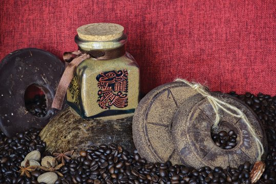 custom painted glass can with traditional aztec pictures coffee bean background with handmade round chocolate 