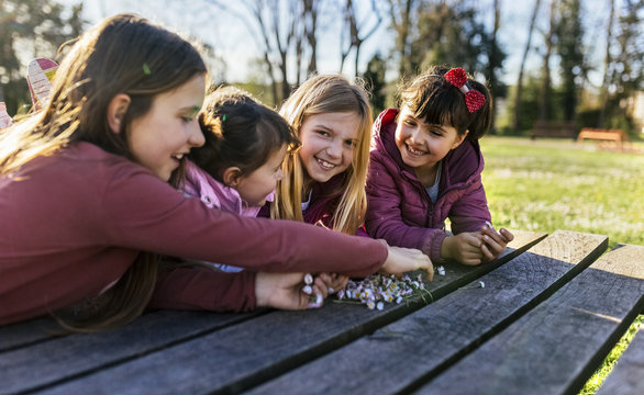 Four girls on a boardwalk with their collected daisies