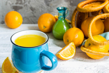 Orange juice glass and fresh oranges