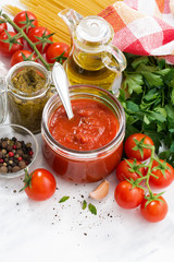 tomato sauce, pesto and ingredients for pasta, vertical