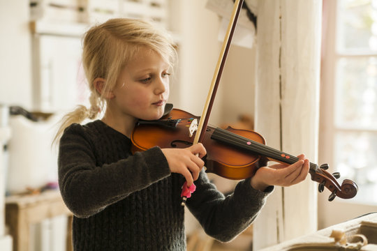 Blond girl playing violin