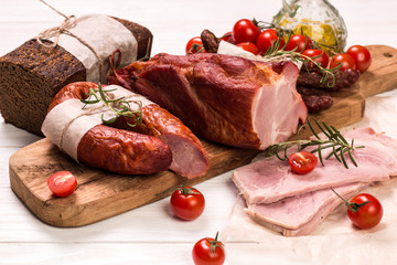 Antipasto catering platter with salami and meat on a wooden background