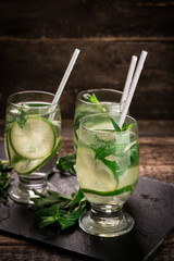 detox water with a lemon, lime and mint on a wooden table
