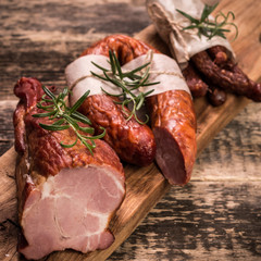 Antipasto catering platter with salami and meat on a wooden background