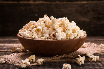 A bowl of popcorn on a wooden table