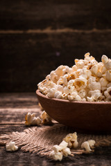 A bowl of popcorn on a wooden table