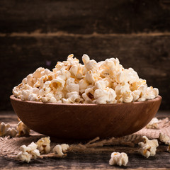 A bowl of popcorn on a wooden table