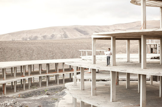 Spain, Fuerteventura, Jandia, architect standing in building shell