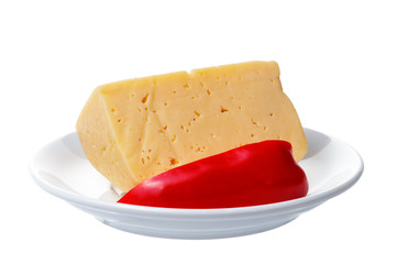 Pieces of cheese and sweet pepper lying on a plate. Objects on a white background.