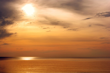 Naklejka na ściany i meble Beautiful sunset above the sea. Gold sea sunset landscape