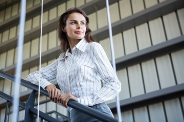 Businesswoman standing near a railing