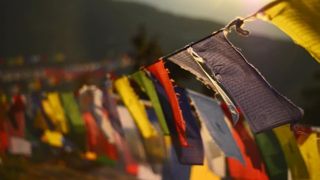 Buddhist prayer flags swaying in the wind. Shallow depth of field.