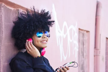 Deurstickers urban girl listening to music © carballo