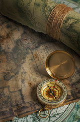Vintage bronze compass and old maps
