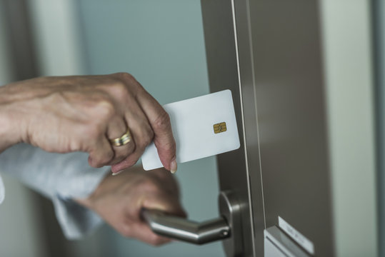 Woman opening door with chip card