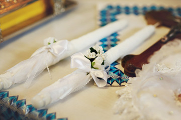 Two white romantic wedding candles in church closeup