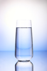 Two-thirds full drinking glass with reflection