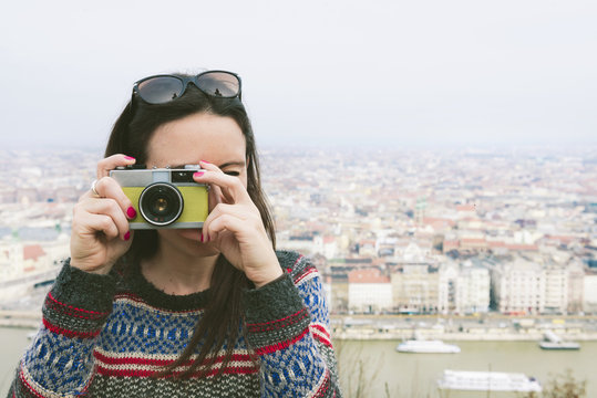 Hungary, Budapest, woman taking a picture from Gellert Hill