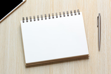 Top view Notebook with blank sheet and pen on wooden table