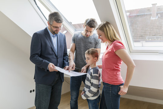 Estate agent explaining family construction plan of a penthouse