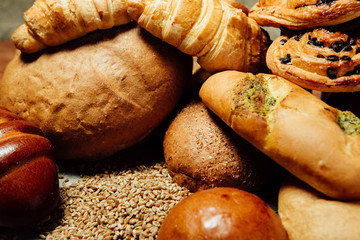 Assortment of baked bread on wood table