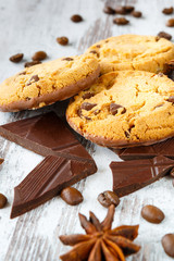Chocolate cookies with chocolate chips, coffe beans and anise on the light wooden background