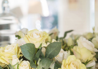 Closeup fake yellow rose flower in front of mirror in room