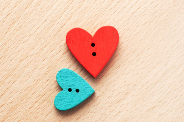 Close up of two wooden heart-shape buttons