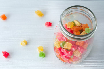 Turkish Delight in glass jar on wood background