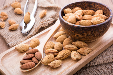 almonds set on the wooden plate, morning light,close up