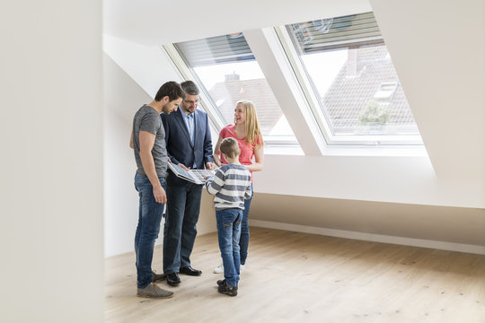 Estate agent showing family sample card in their new penthouse