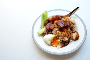 Rice with crispy pork, chinese sausage, soft boiled egg and red sauce